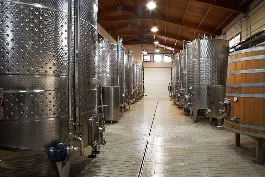 two rows of lying aluminum wine storage tanks at 'Wine Art Estate' plant